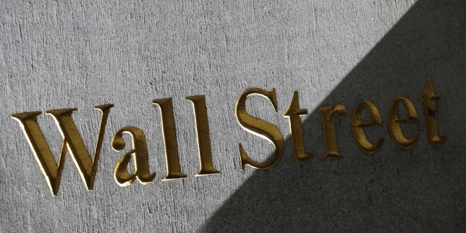 FILE - This March 4, 2013 file photo shows a sign for Wall Street on the side of building near the New York Stock Exchange, in New York. U.S. stocks are opening lower Tuesday, Sept. 23, 2014, following disappointing economic news and U.S.-led airstrikes against Islamic State militants in Syria. (AP Photo/Mark Lennihan, File)