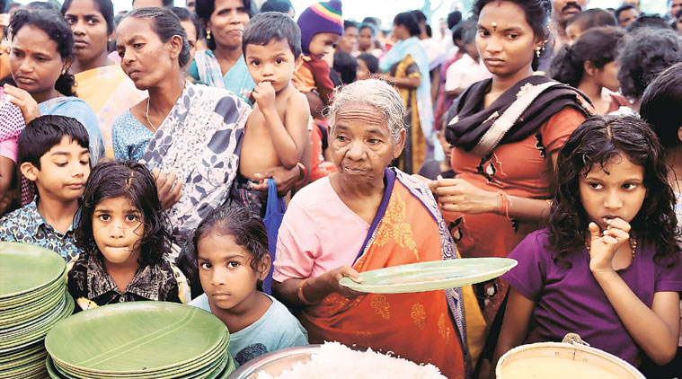 People wait for food at a relief camp in Chennai,Thursday. (Source: PTI) 