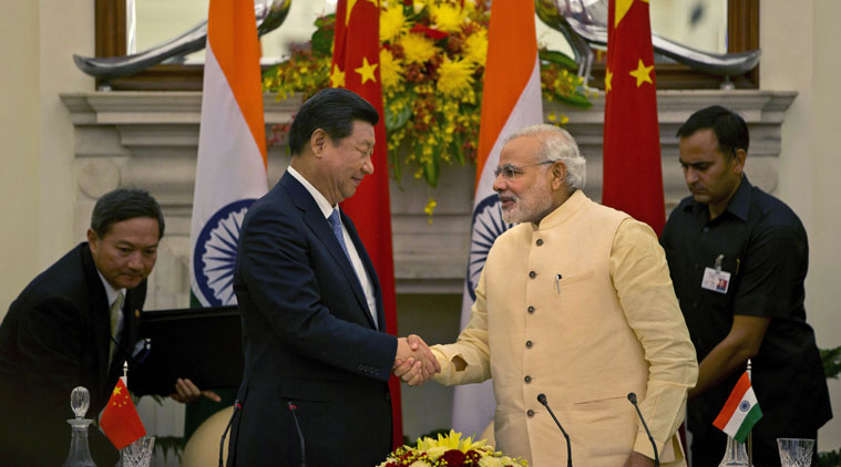 Chinese President Xi Jinping shakes hands with Indian Prime Minister Narendra Modi, right after signing agreements in New Delhi on Thursday. (Source: AP)